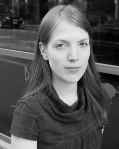 A smiling headshot of the artist Olivia Viitakangas.