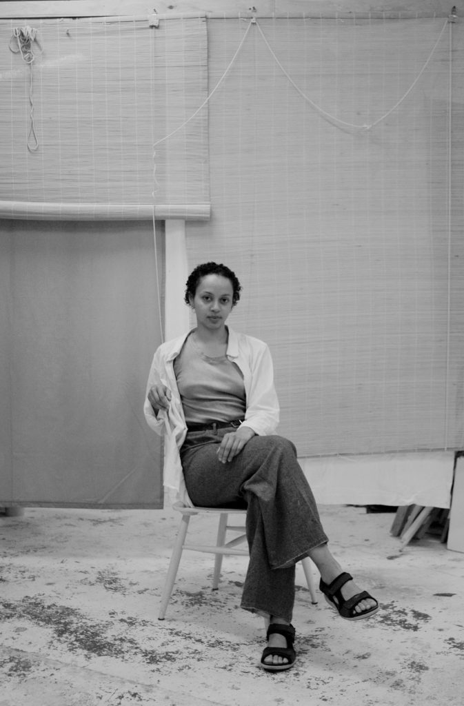 woman sitting in a chair in a studio set up
